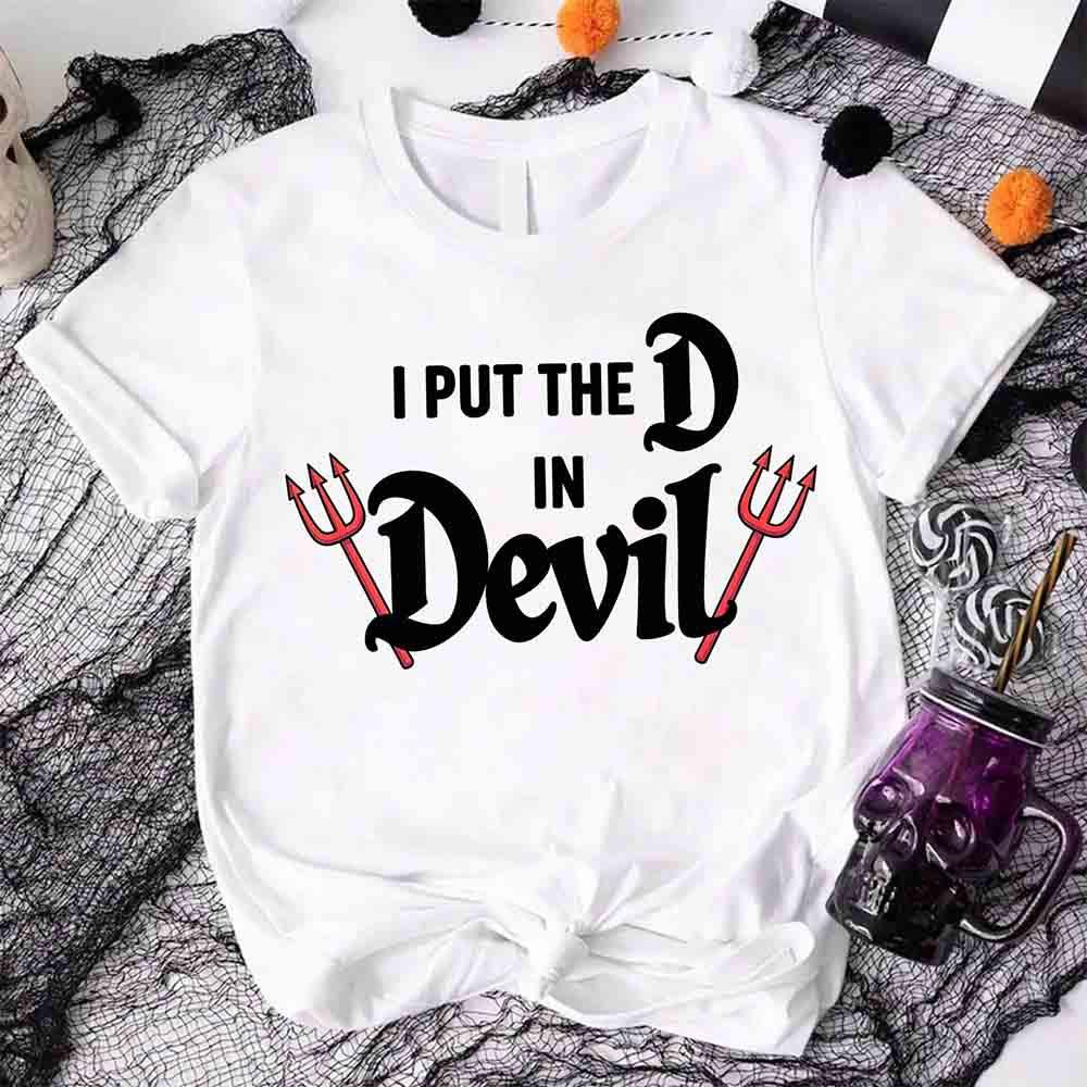 White crew-neck T-shirt with black 'I PUT THE D in Devil' graphic