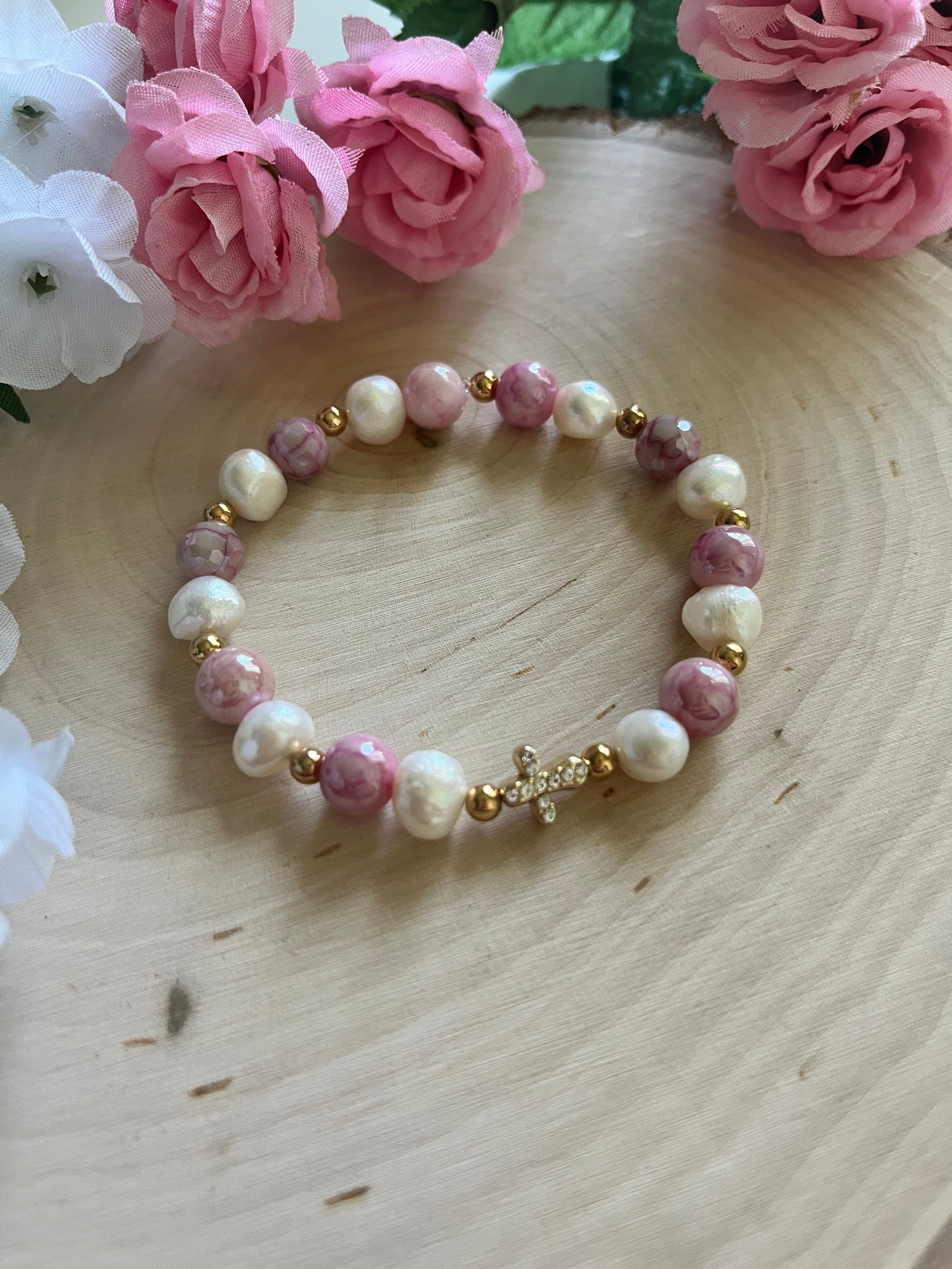 Pink and white pearl bead bracelet with gold cross charm and golden details