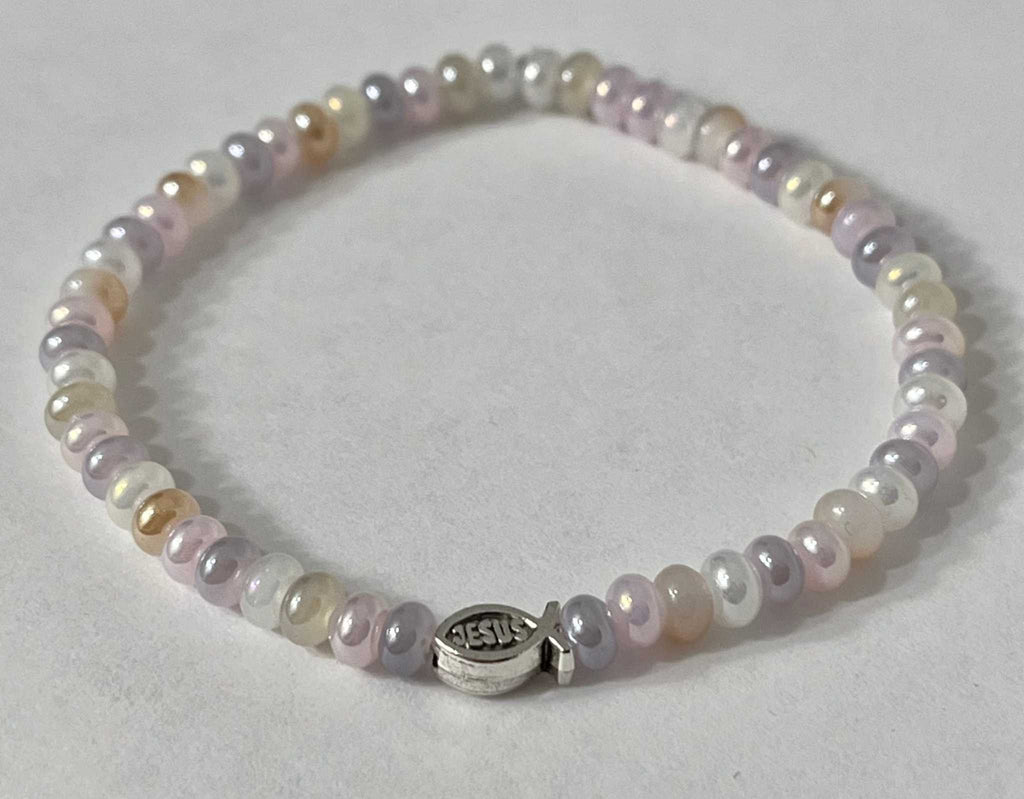 Bead bracelet with pastel purple and white beads and a round silver Jesus charm