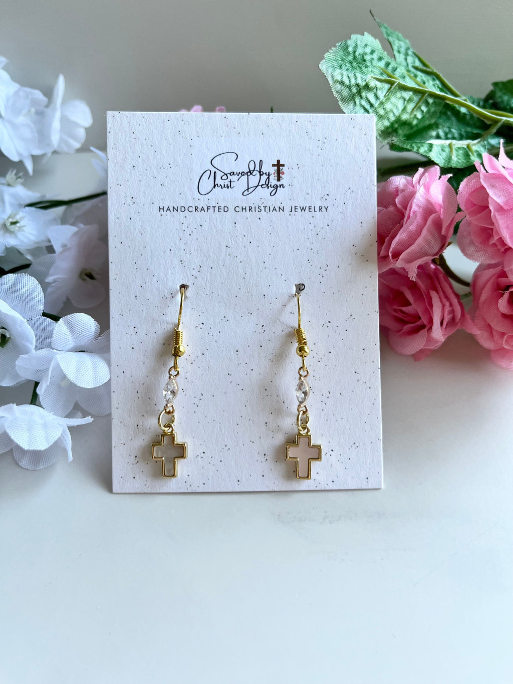 Gold-tone cross drop earrings on card, pair with small bead accents.