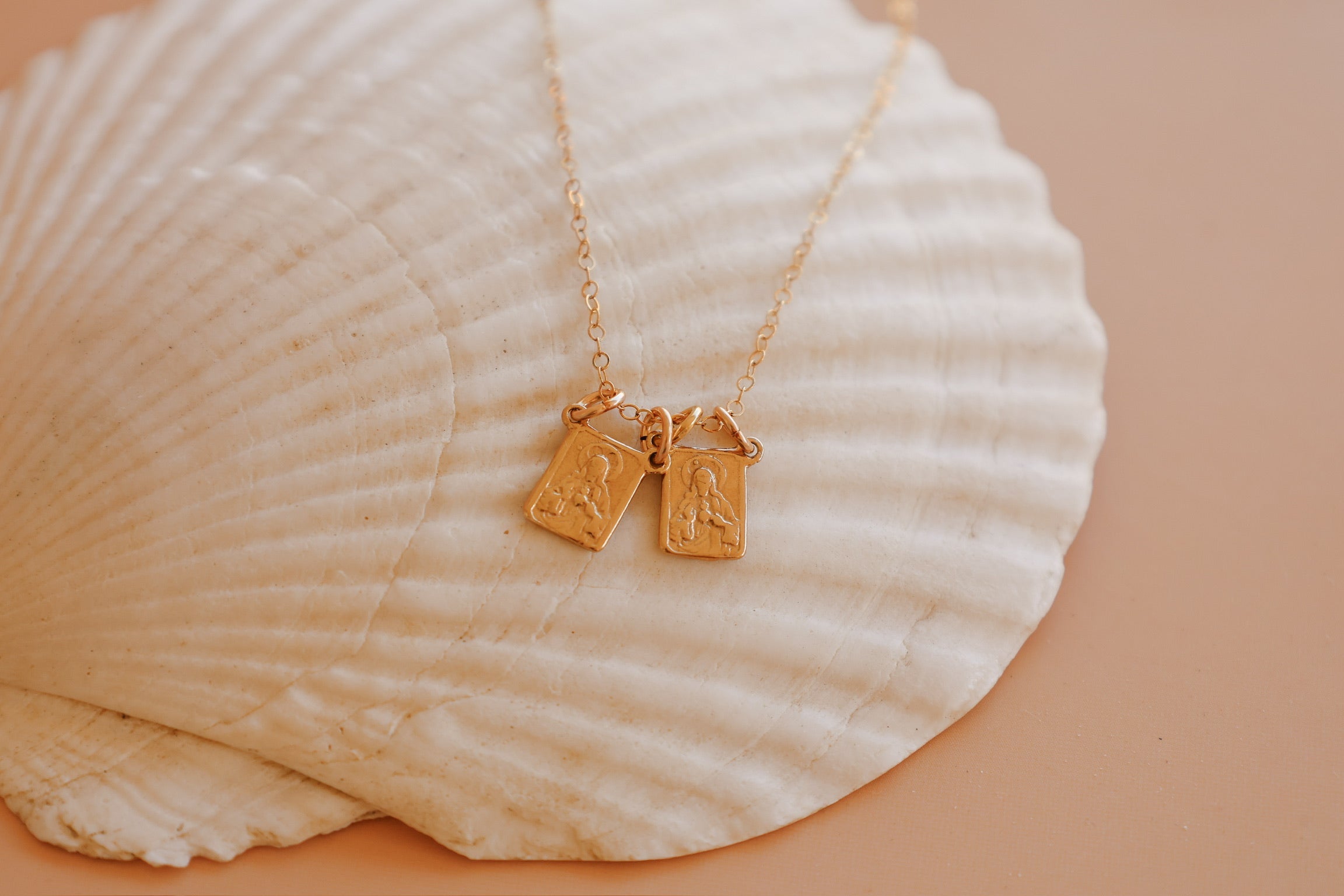 Scapular charm necklace with two small rectangular pendant charms hanging on a chain