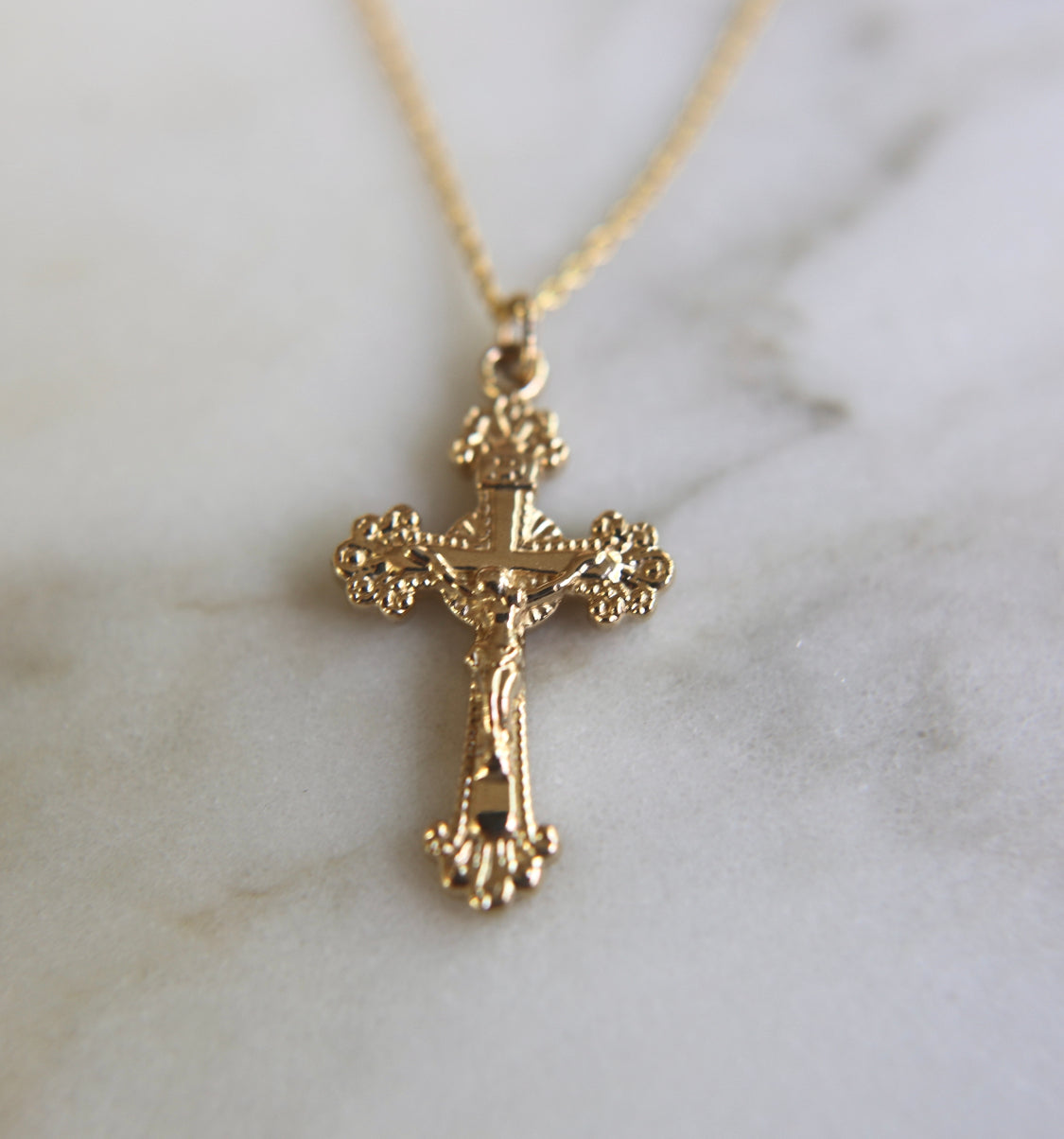 14k gold crucifix pendant necklace on a thin chain, full cross charm.