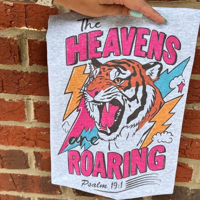 Light blue Christian T-shirt with tiger graphic and 'The Heavens are roaring' quote