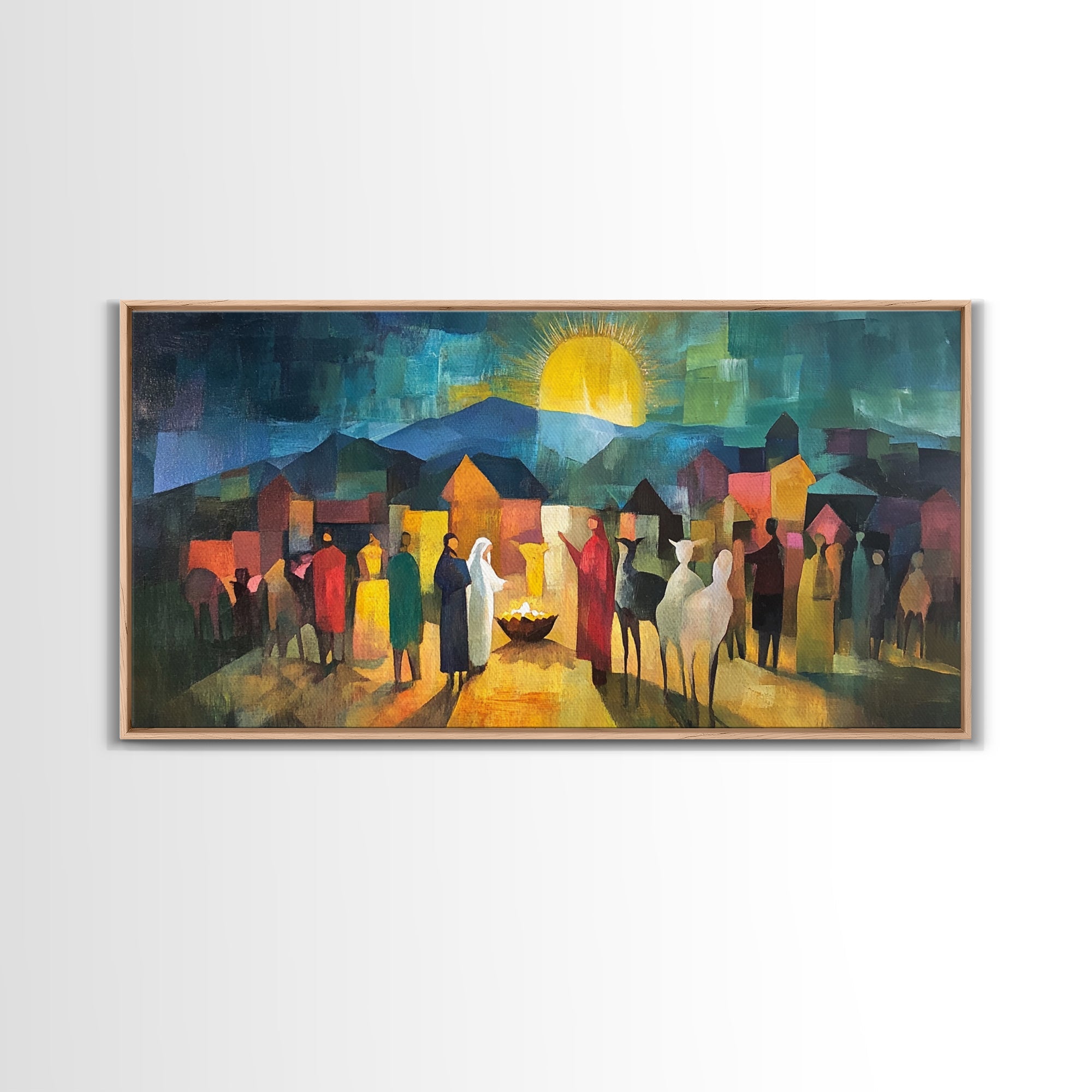Framed nativity scene art print with warm sun glow, town houses, and standing figures
