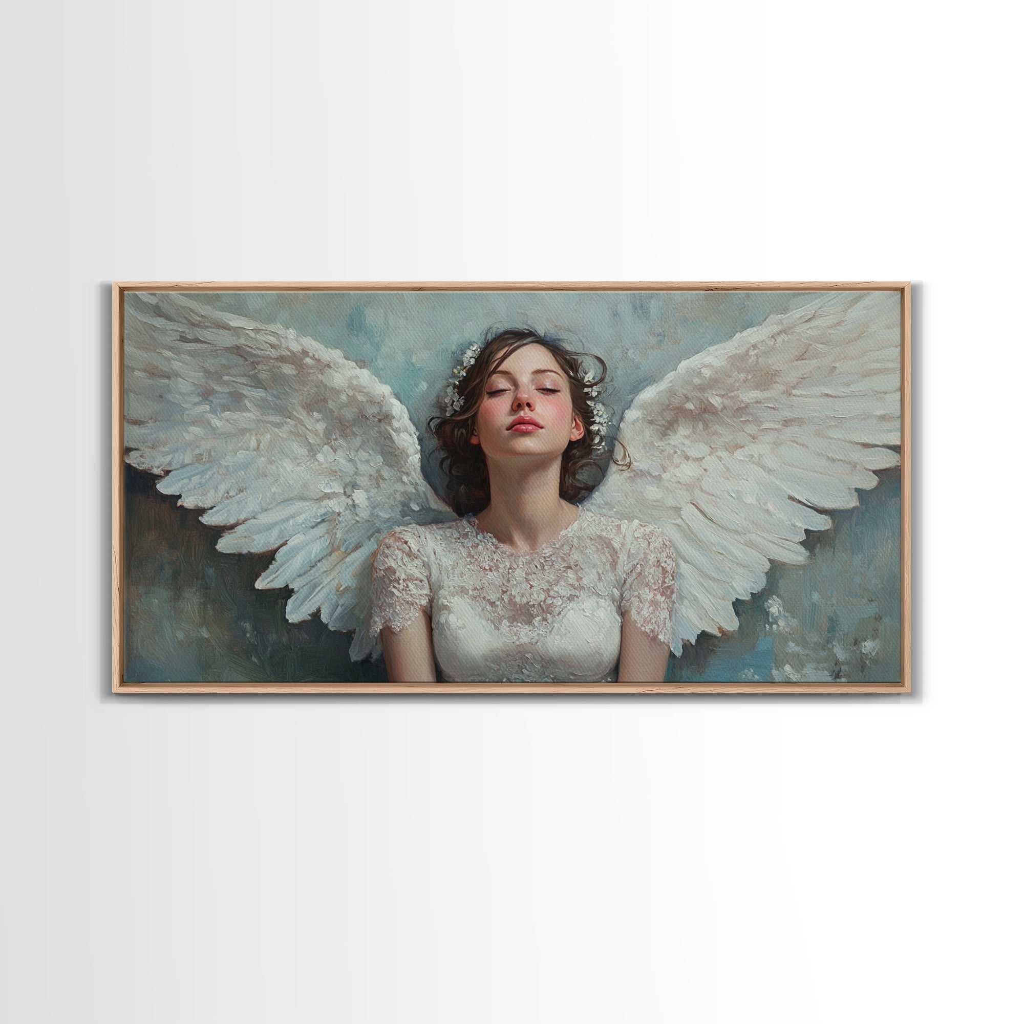 Framed angel canvas print with white wings and pale blue background, brown frame