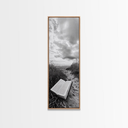 Light oak framed canvas print of open Bible on a sandy beach path under cloudy sky