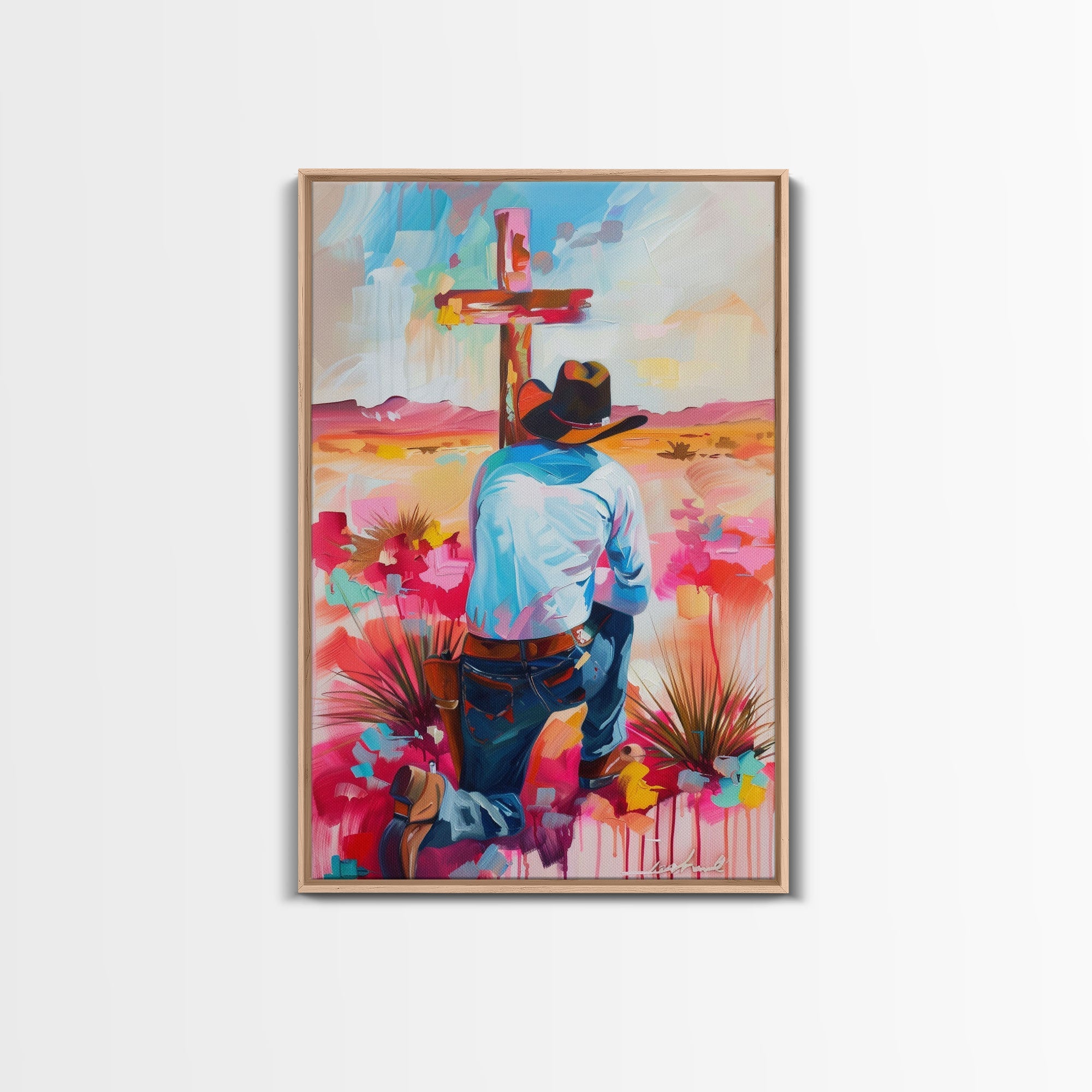 Framed canvas print of a cowboy praying at a red cross, colorful floral landscape