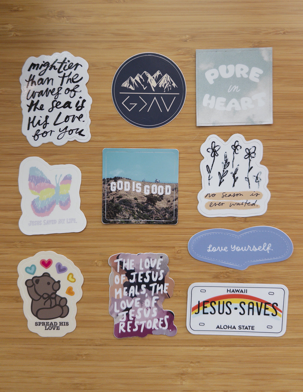 Religious stickers featuring mountains, hearts, and a 'Jesus-saves' label in color