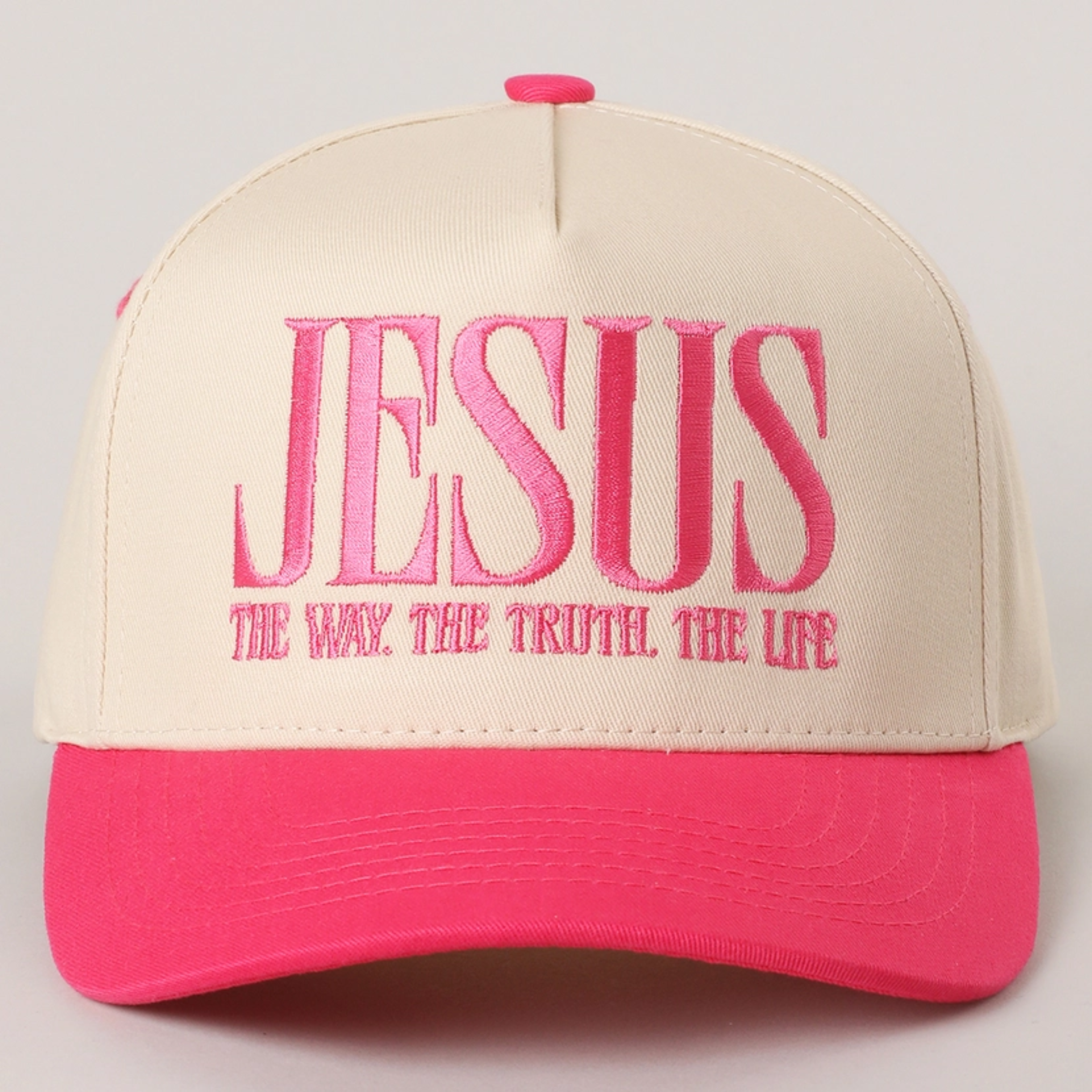 Sand and dark pink baseball cap with embroidered “JESUS” and slogan on front
