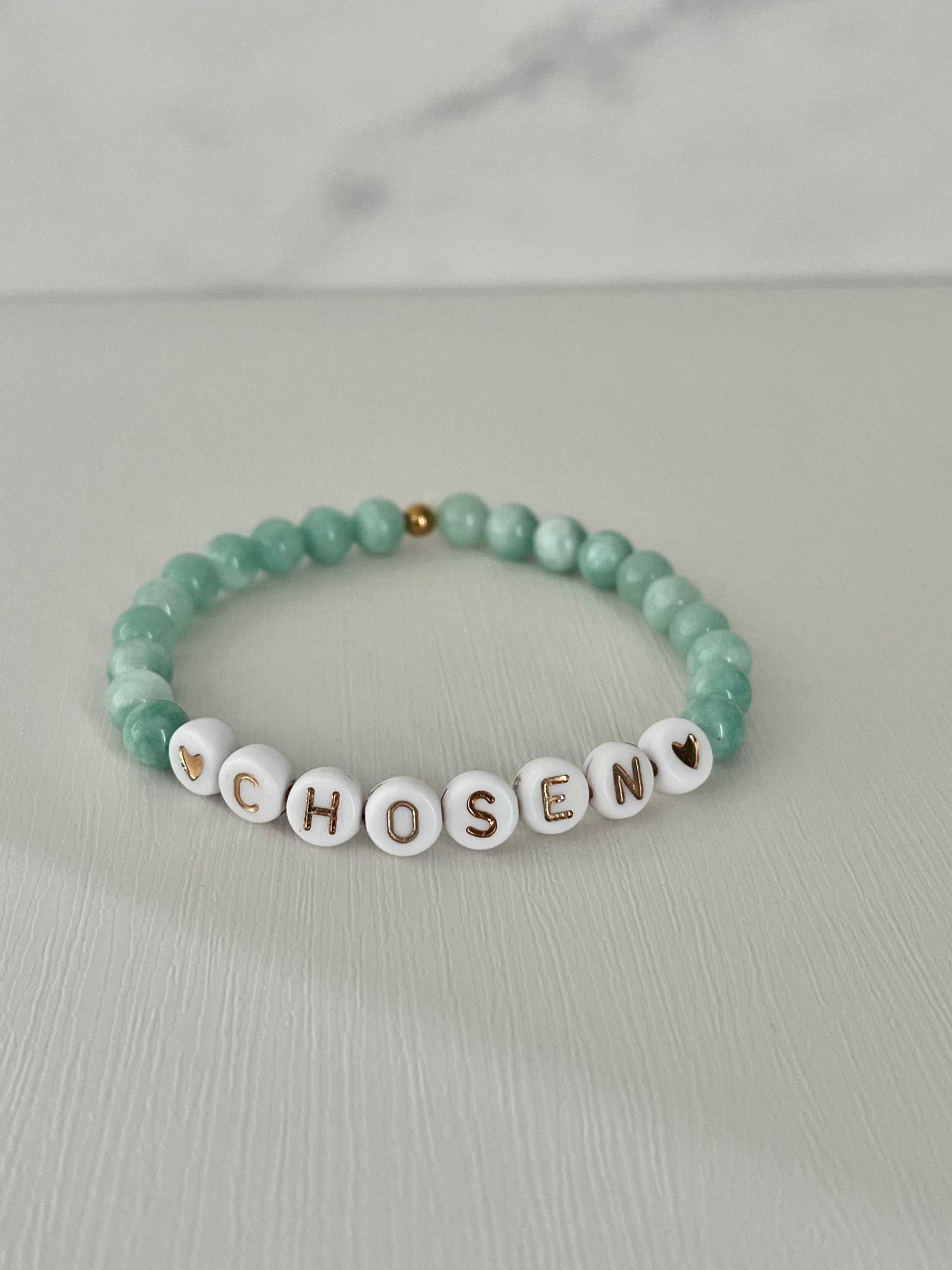 Jade green bead bracelet with white letter beads spelling CHOSEN