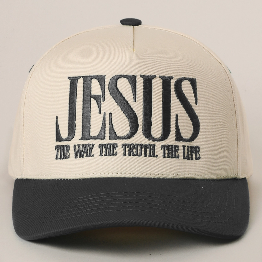 Sand baseball cap with black brim and black embroidered “JESUS” slogan on front