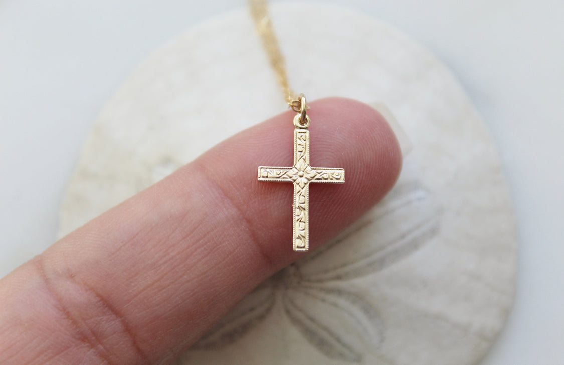 Gold cross pendant necklace with beaded chain, small square detailing on cross