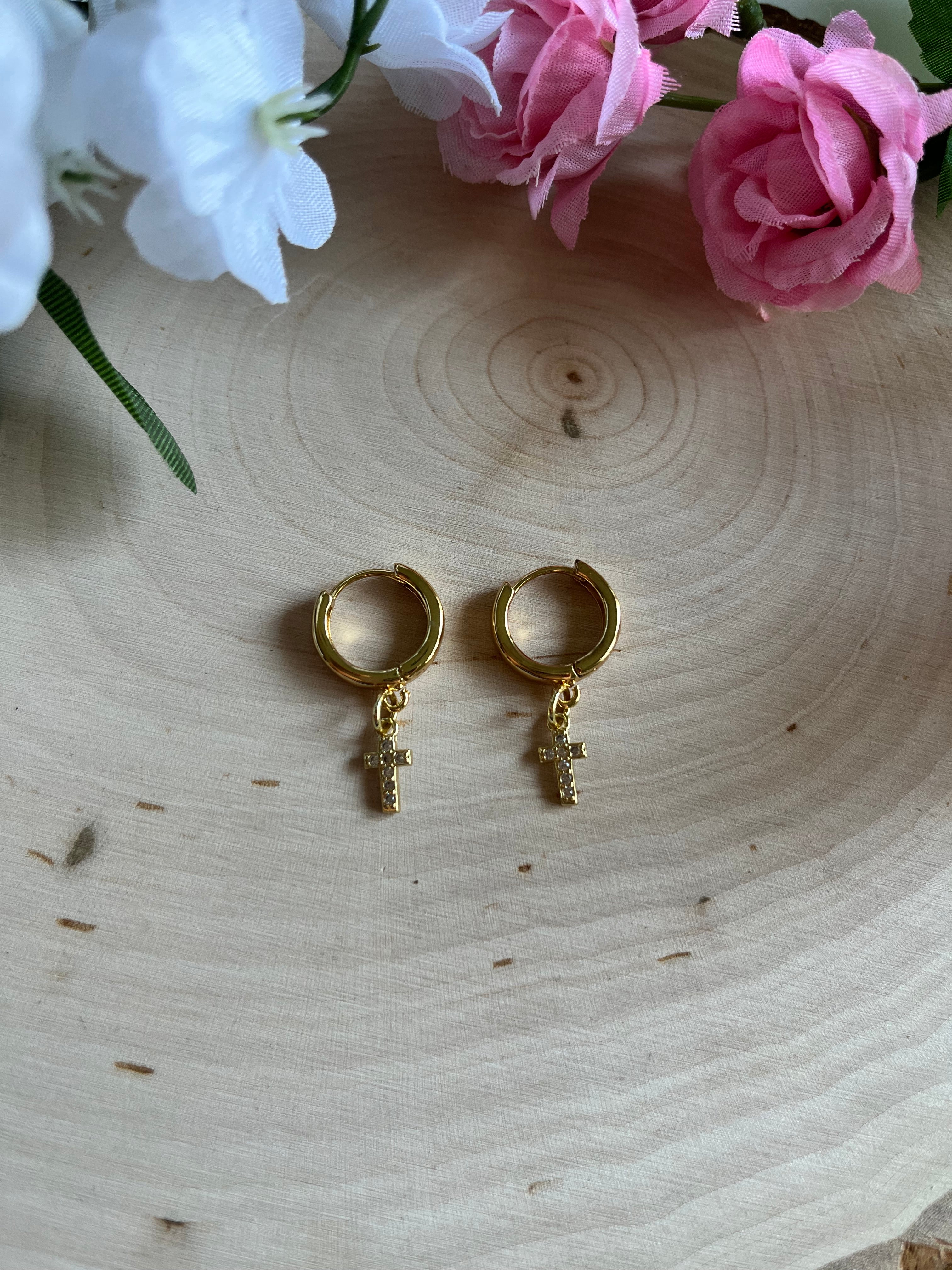 Gold hoop earrings with small cross drop charms