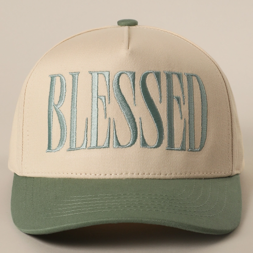 Cream baseball cap with embroidered BLESSED logo and sage green curved brim