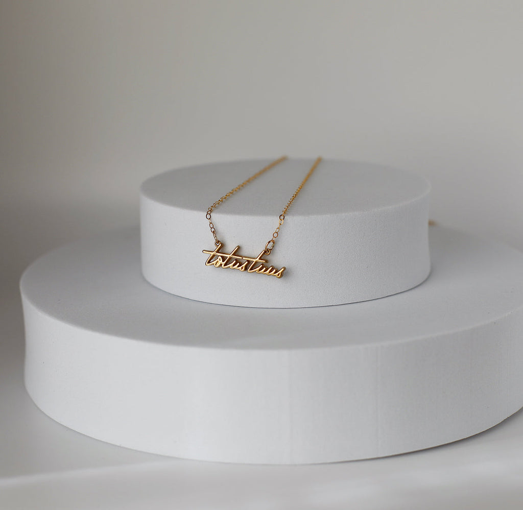 Gold-tone script pendant necklace with fine chain links