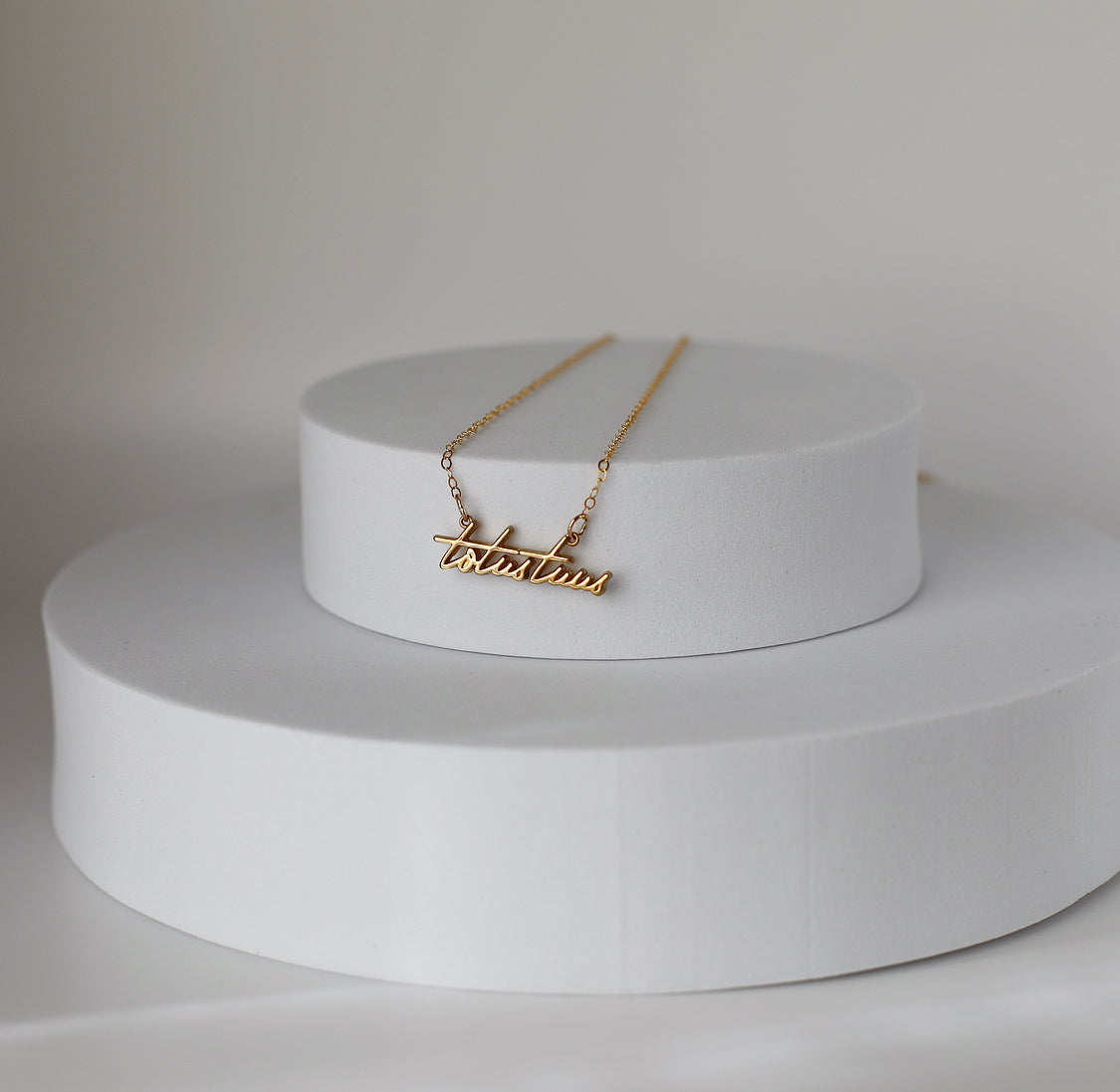 Gold-tone script pendant necklace with fine chain links
