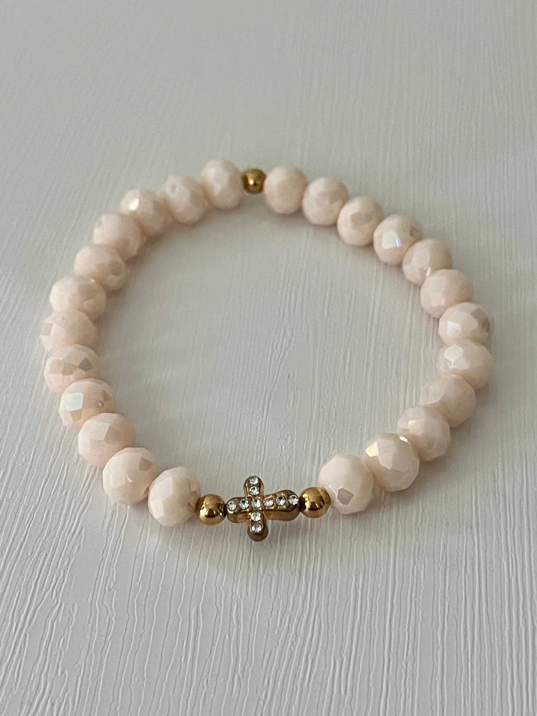 Beaded cross bracelet with pale pink round beads and rhinestone cross charm