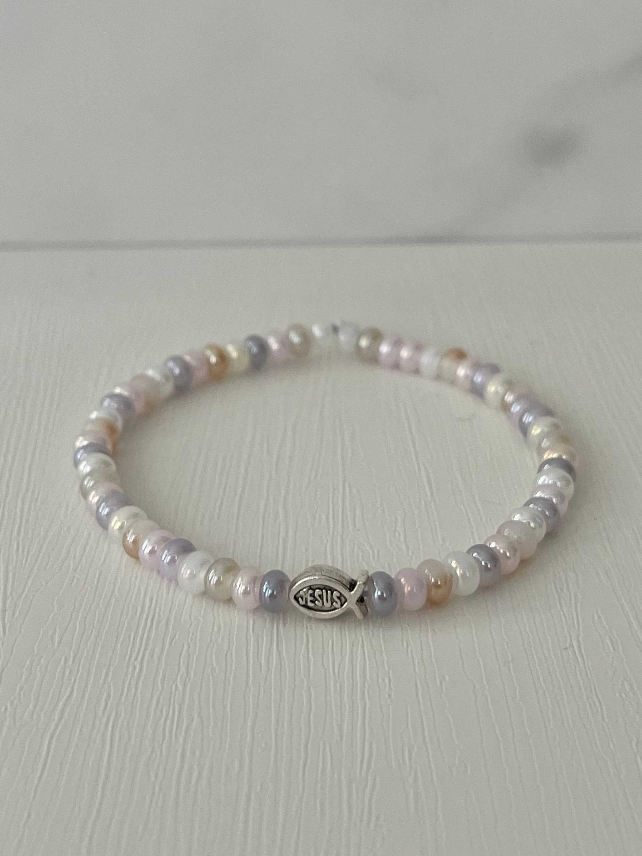 Freshwater pearl bead bracelet with round beads and small “JESUS” charm