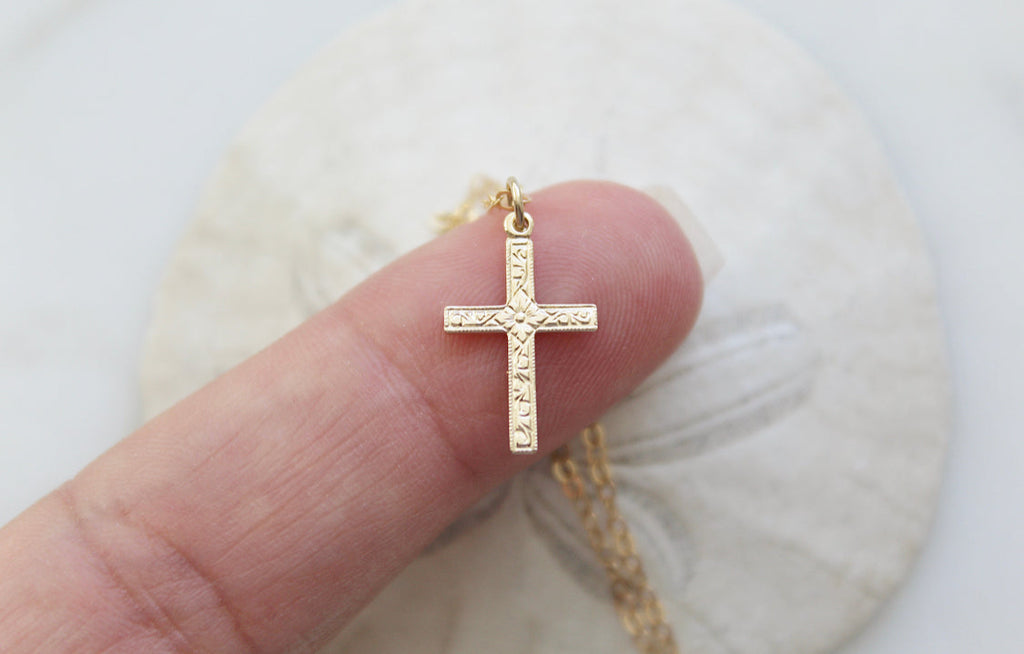 Gold cross pendant necklace with rectangular center cross details
