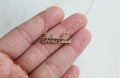 Gold-tone script pendant necklace with small cross detail