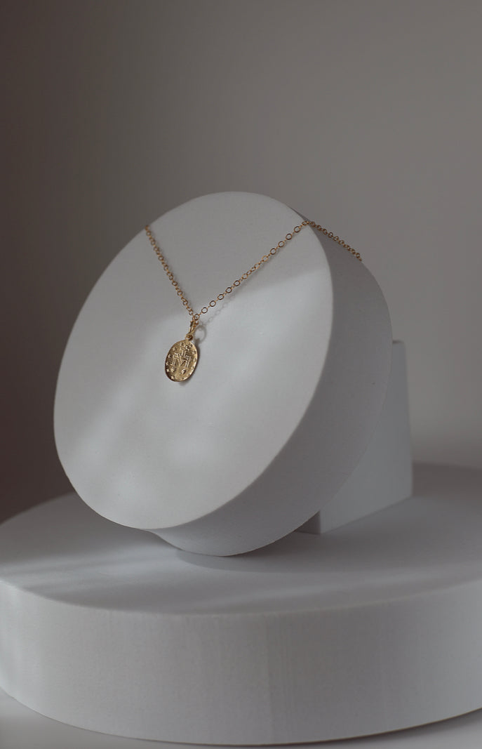Silver-tone medal necklace with oval pendant on a fine chain