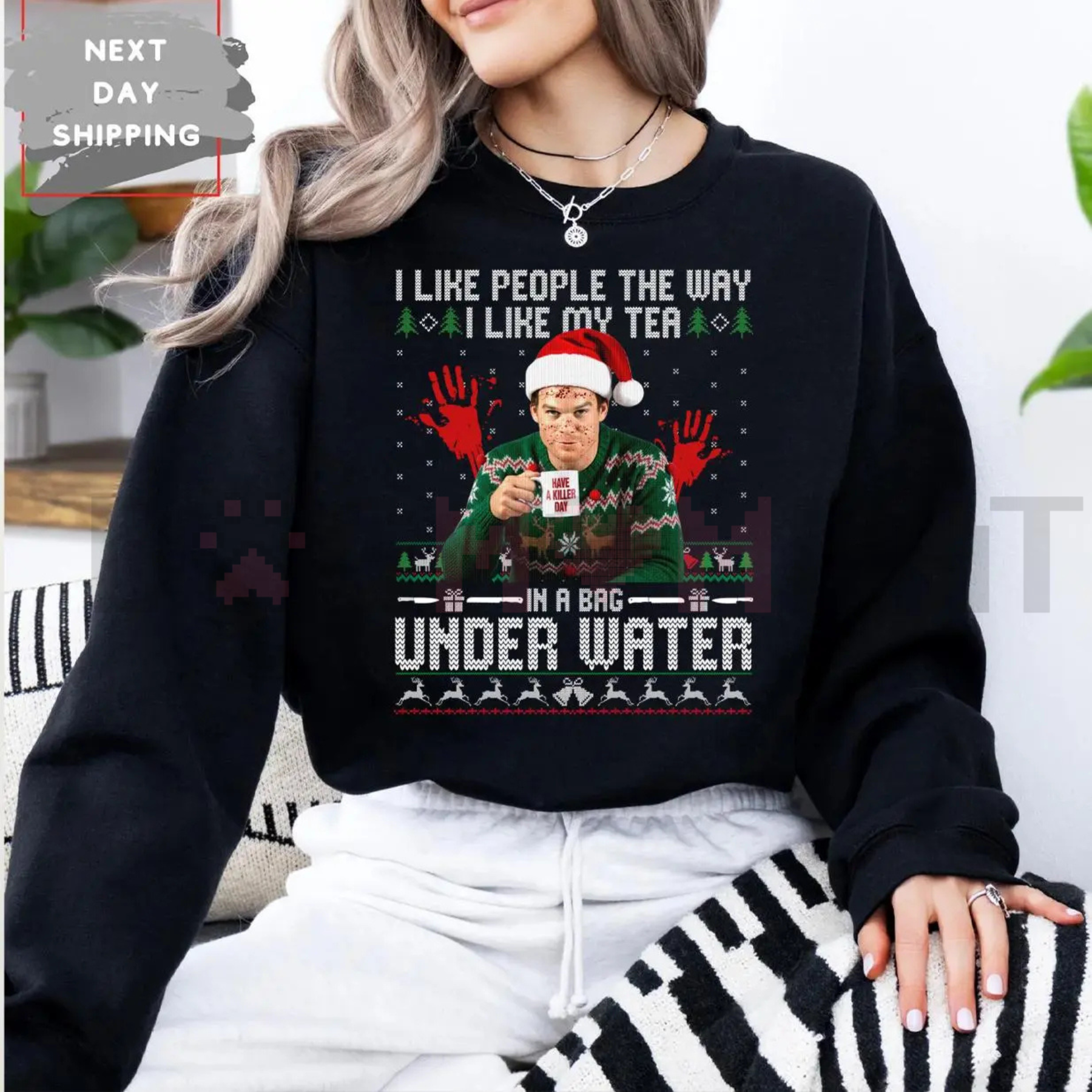 Black crewneck sweatshirt with Under Water graphic and holiday hat print