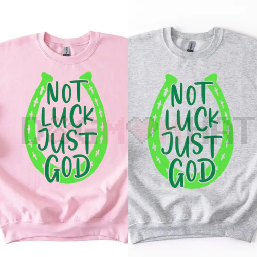 Pink and sport grey sweatshirts with green horseshoe graphic reading 'NOT LUCK JUST GOD'.