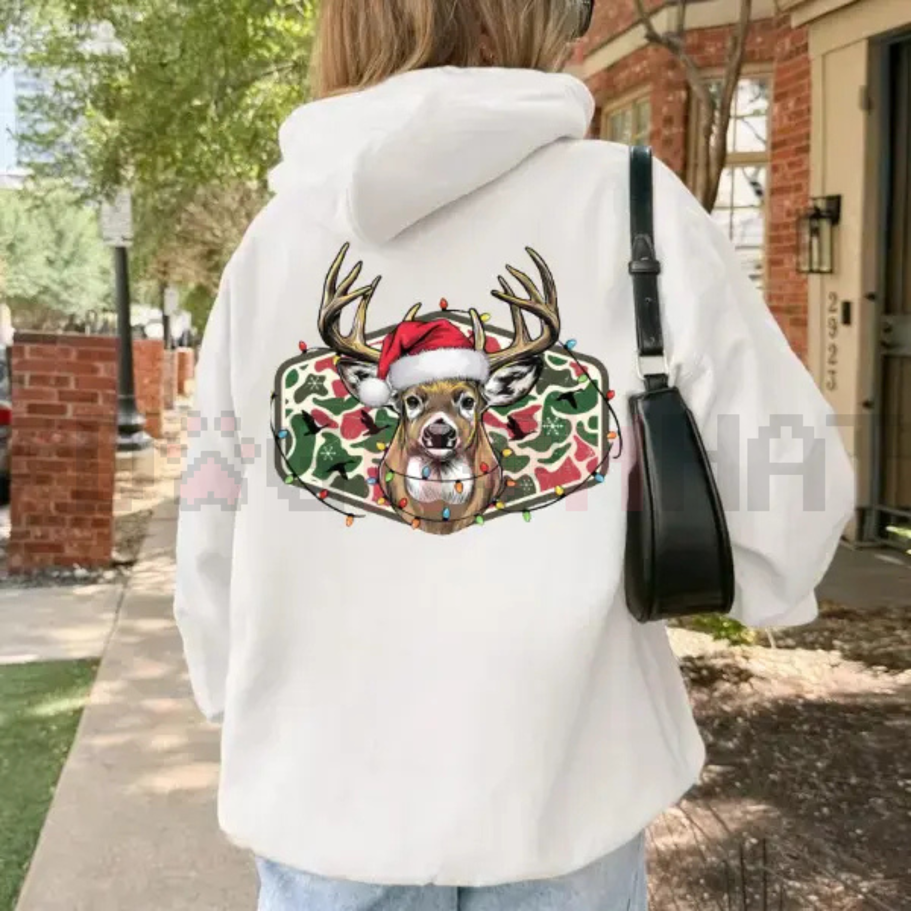White hoodie with Christmas deer camo graphic on the back and hood up.