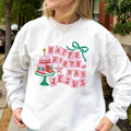 White unisex crewneck sweatshirt with 'Happy Birthday Jesus' graphic