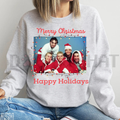 Light gray crewneck sweatshirt with colorful Christmas group graphic and red text