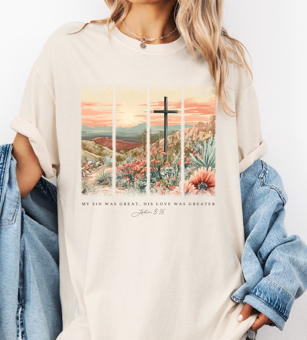 Ivory graphic T-shirt with cross over desert floral landscape and scripture quote