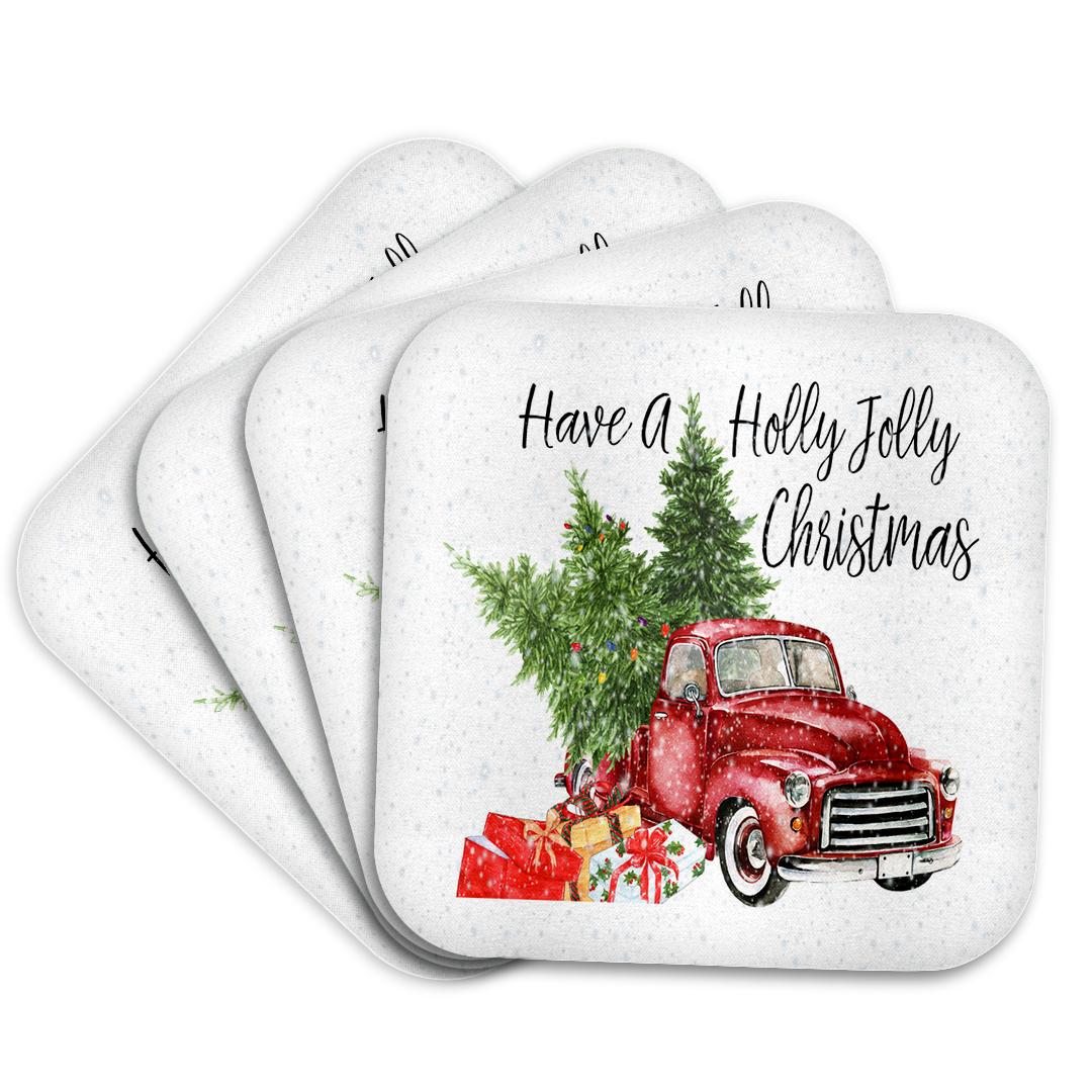 Four round-edge coasters with red truck, holly leaves, and 'Have a Holly Jolly Christmas'