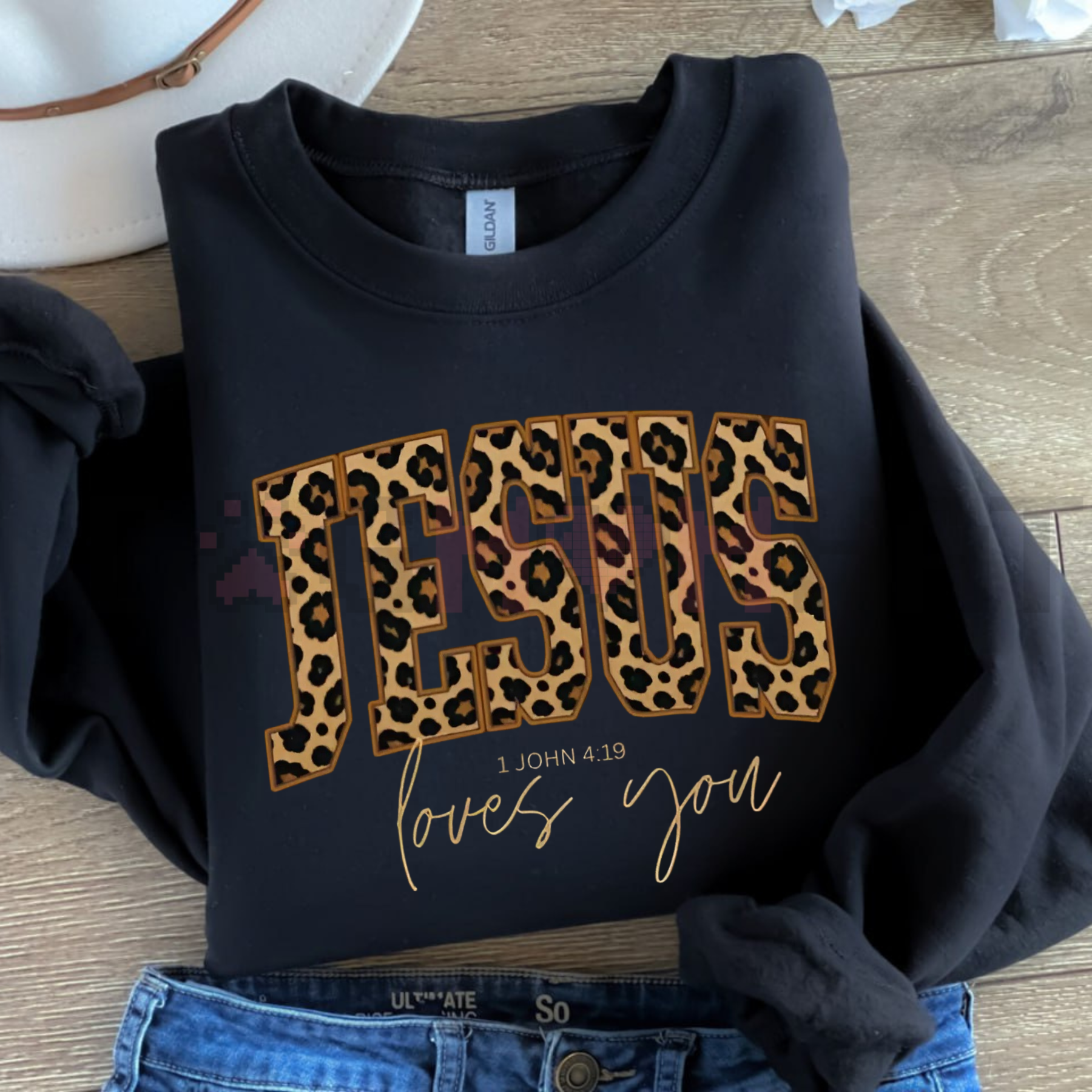 Black crewneck sweatshirt with leopard JESUS print and gold love you script.
