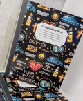 Black composition book with 'Composition Book' label and colorful Christian icons on cover