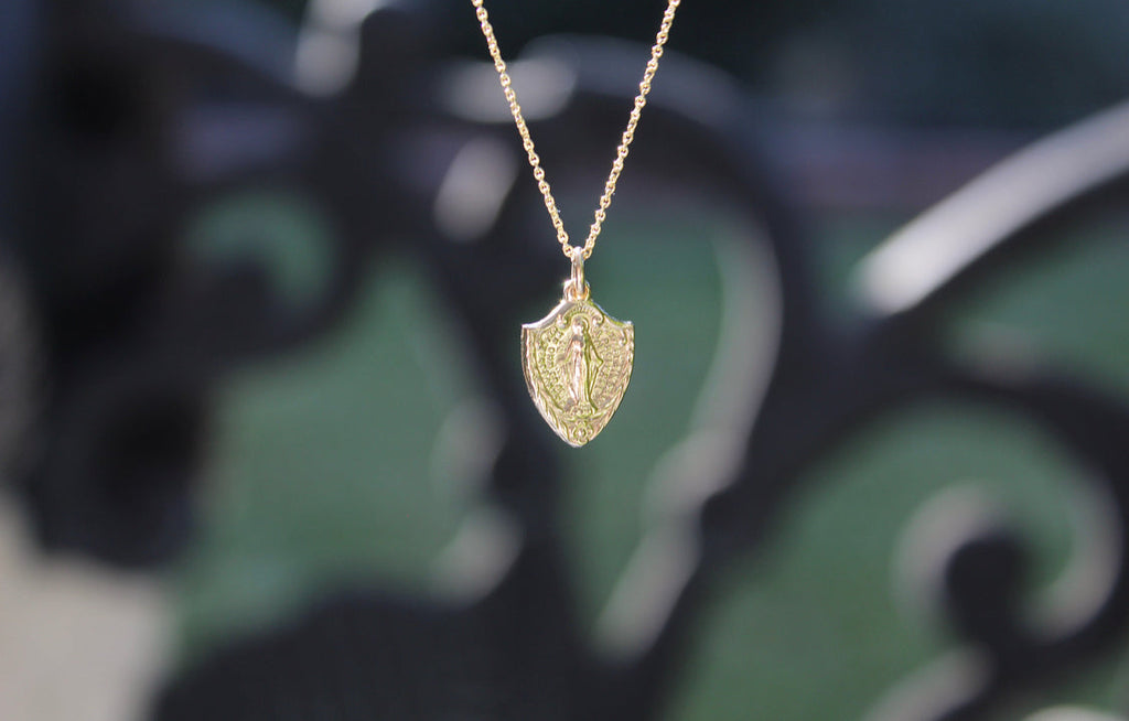 14K gold shield pendant necklace with Miraculous Medal style figure centerpiece