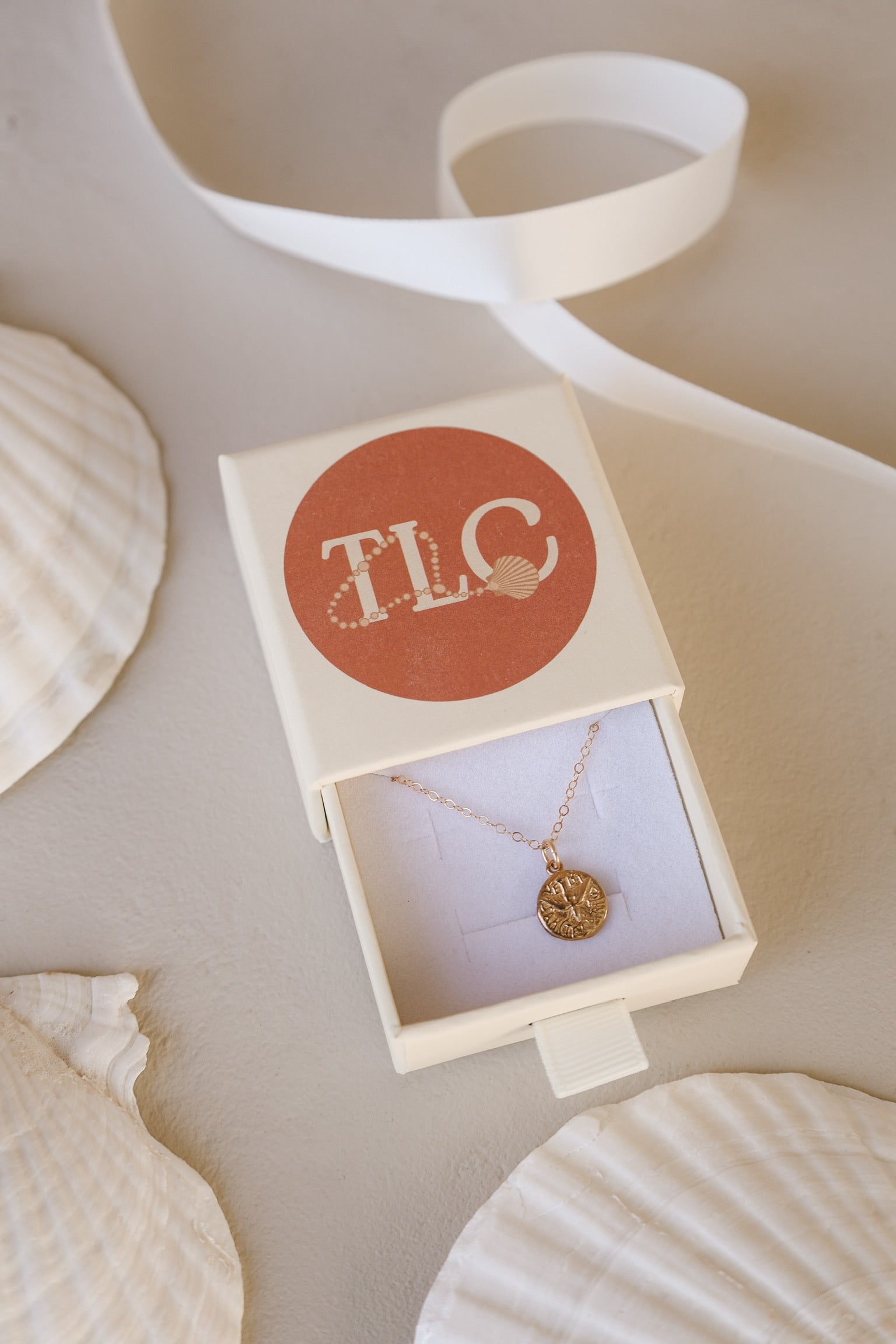 Gold Holy Spirit pendant necklace in gift box with TLC label