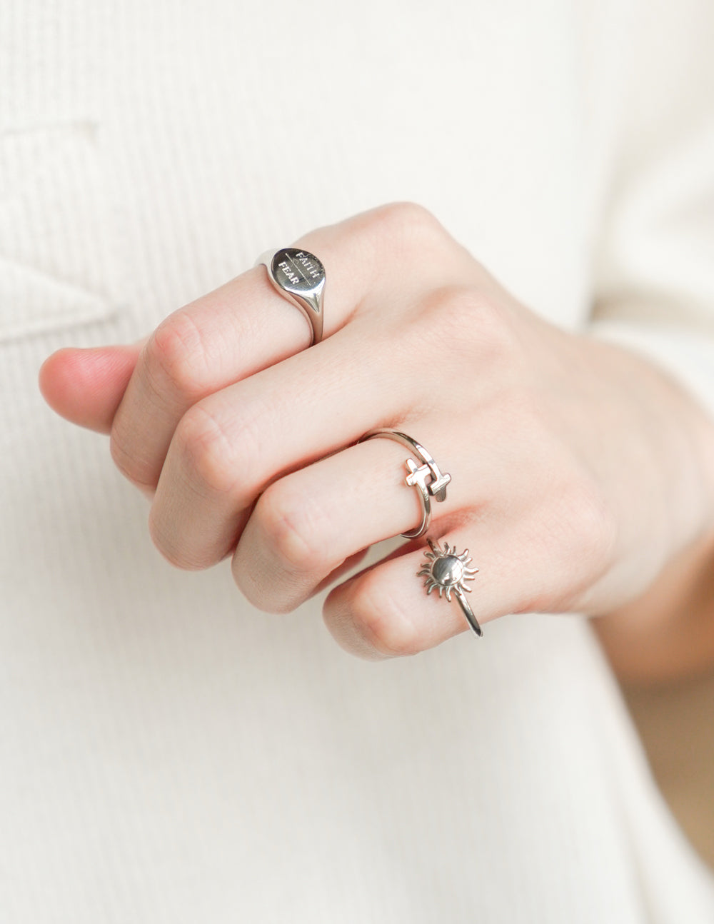 Silver cross wrap ring with raised cross centerpiece on open band