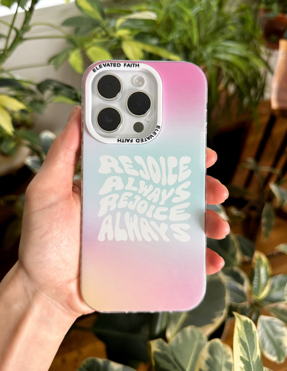 Rejoice Always phone case in pastel pink-blue gradient with hand-held view