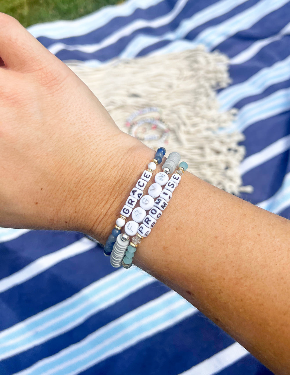 Beaded promise letter bracelet with blue seed beads and white letter beads on wrist