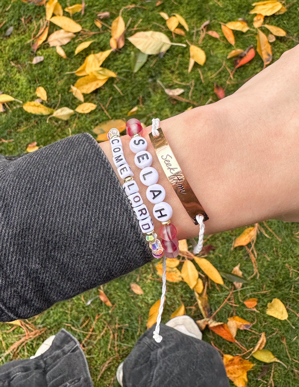 Selah letter bracelet with red and white beads and raised "SELAH" letter charms