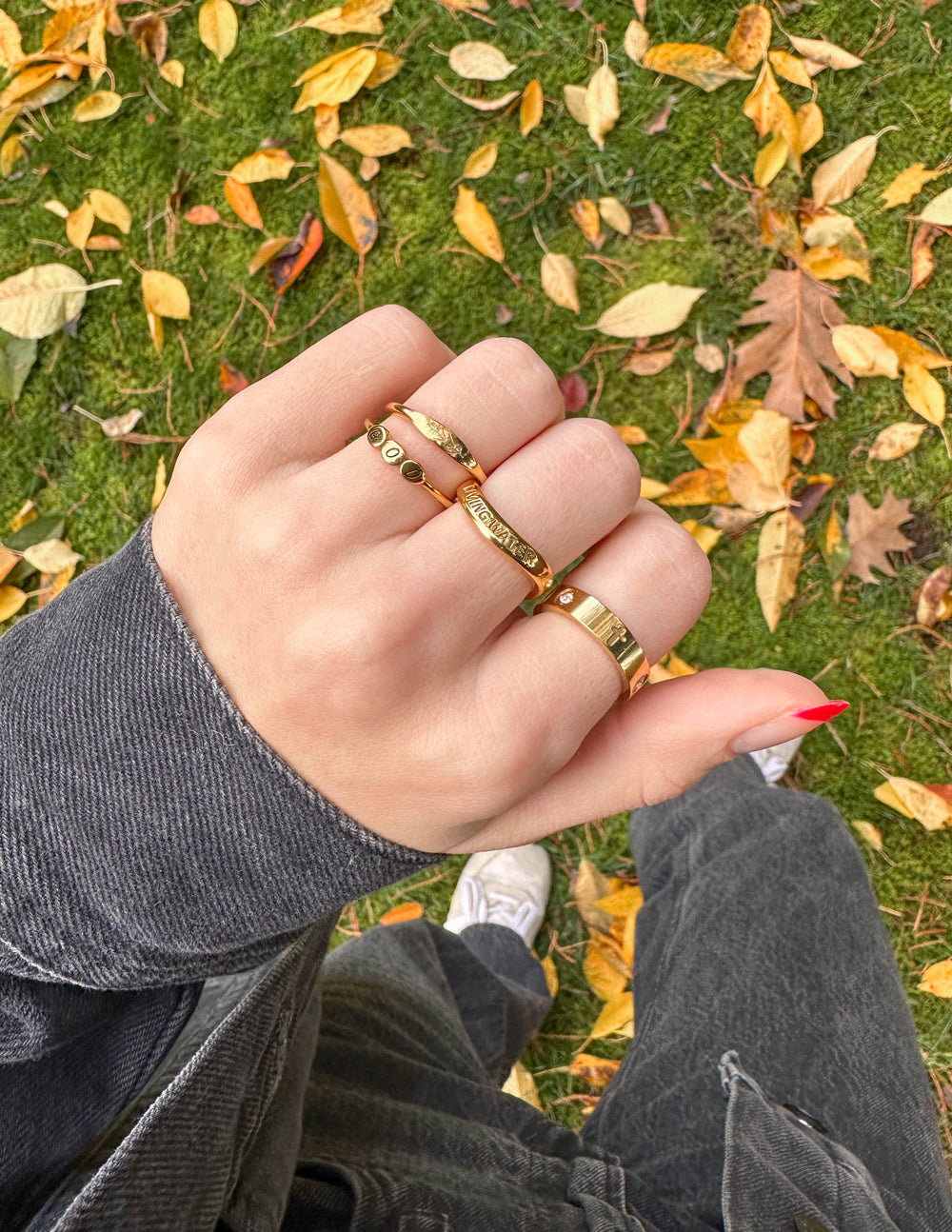Gold cross-detail eternity ring with small clear stones, slim band