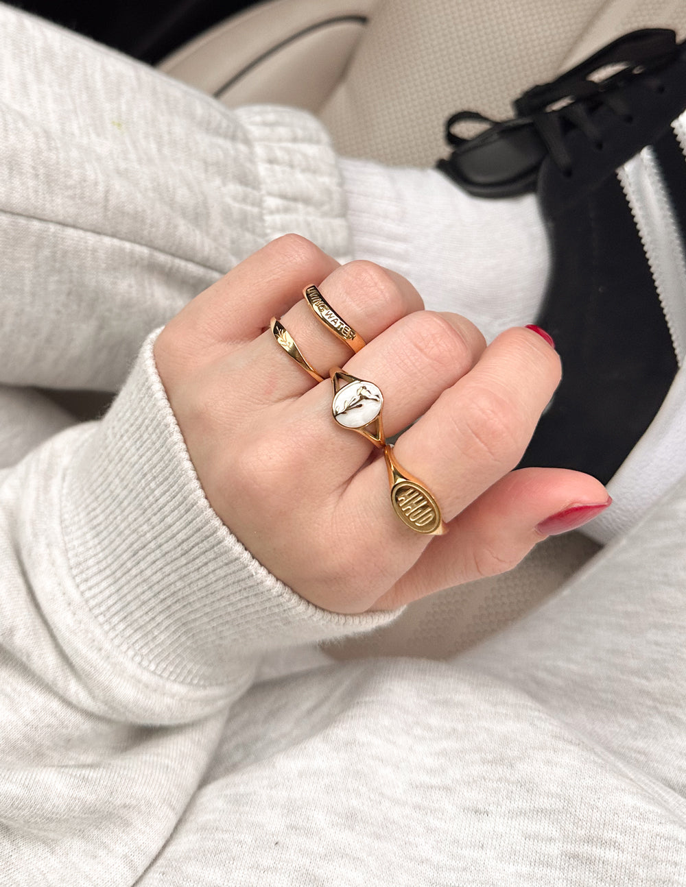 Gold-tone ring set with oval-stone ring and two engraved bands