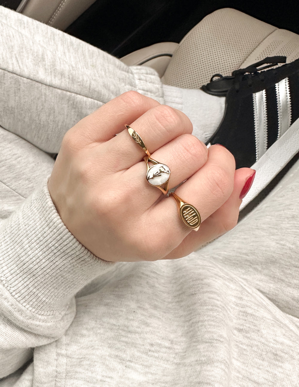 Gold vine ring on hand, slim band with vine engraving