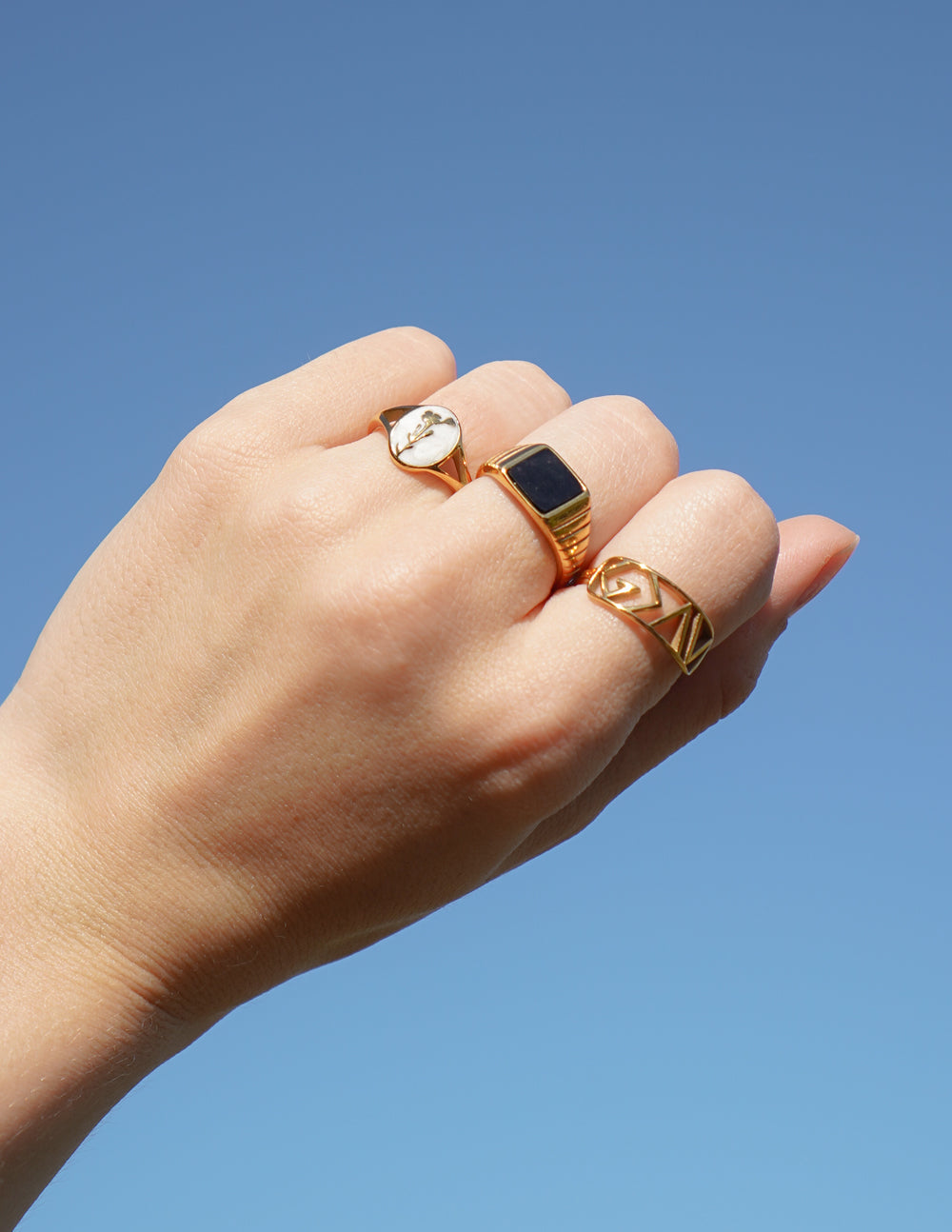 Gold-tone signet ring with dark blue enamel square face