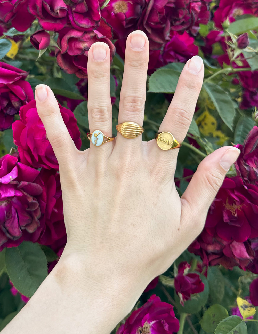 Gold-tone ribbed band ring on finger with stacked look