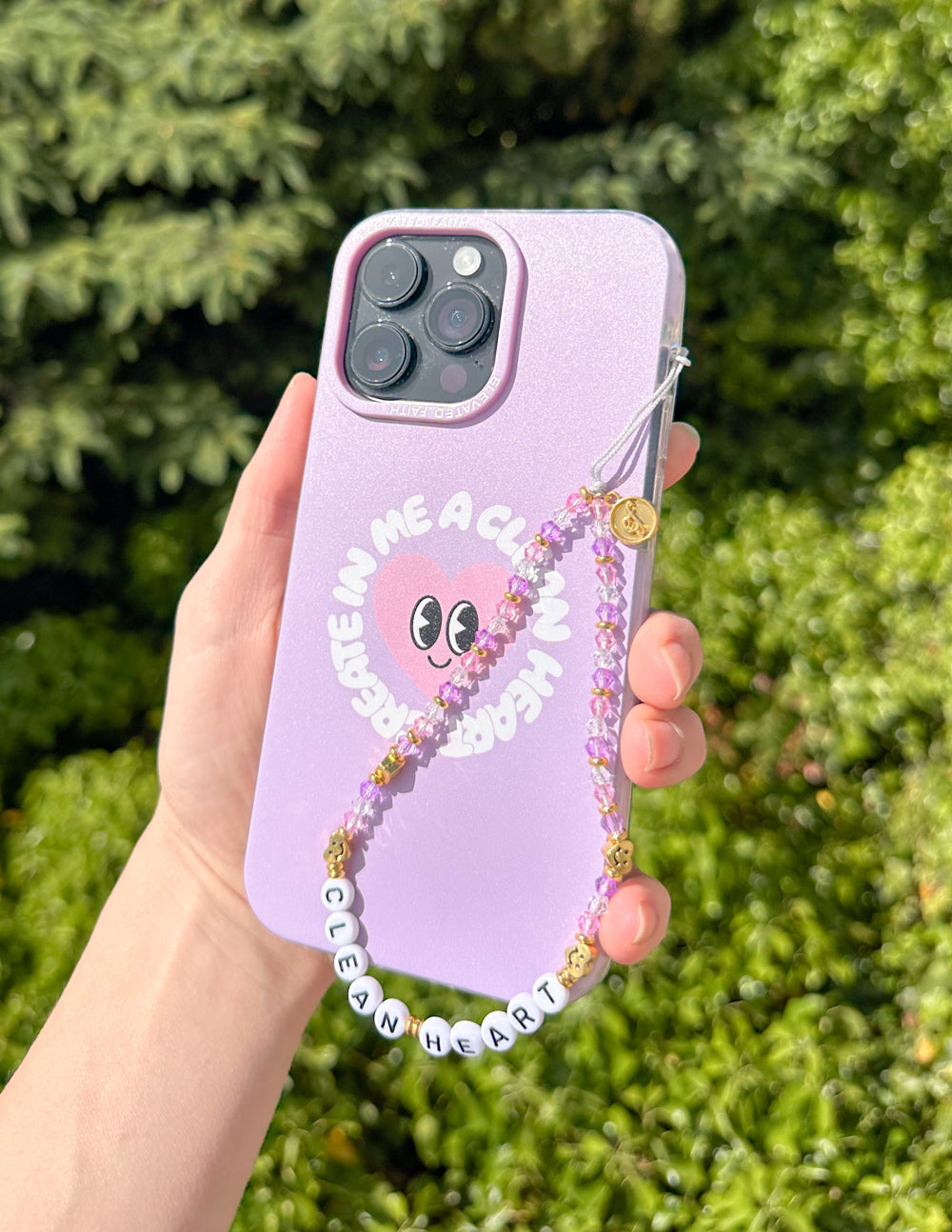 Purple phone case with beaded heart charm and dangling bead strand