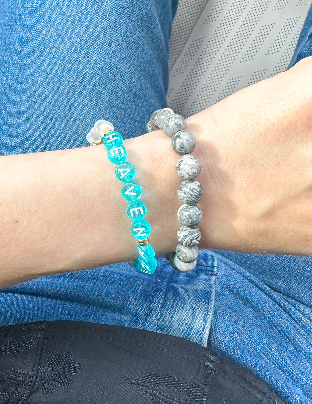 Turquoise letter beaded bracelet on wrist with gold-tone spacers