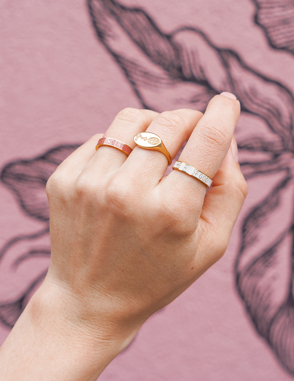 Disciple ring, gold-tone engraved band on finger, cross and globe arrow detail