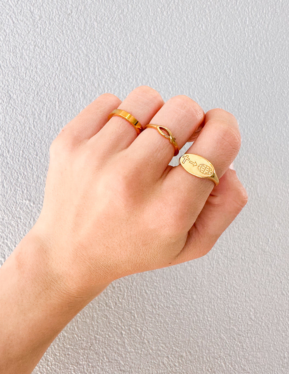 Gold ring with a small engraved crest detail on top