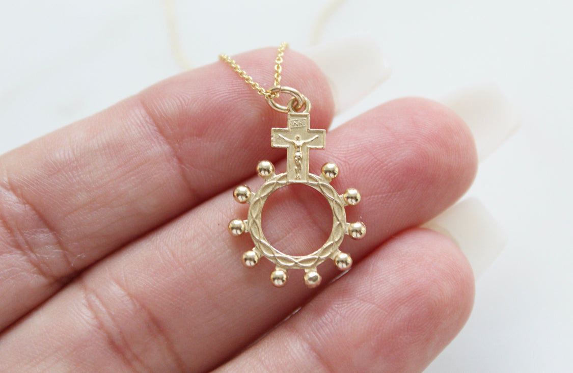 14k gold rosary bead pendant with cross above and round ring with bead border